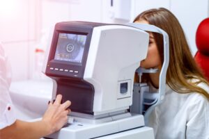 A woman getting her eyes checked at an eye clinic for epiretinal membrane.