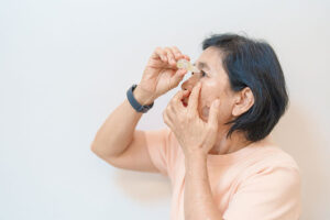 Woman using eyedrops for symptomatic relief for cataract